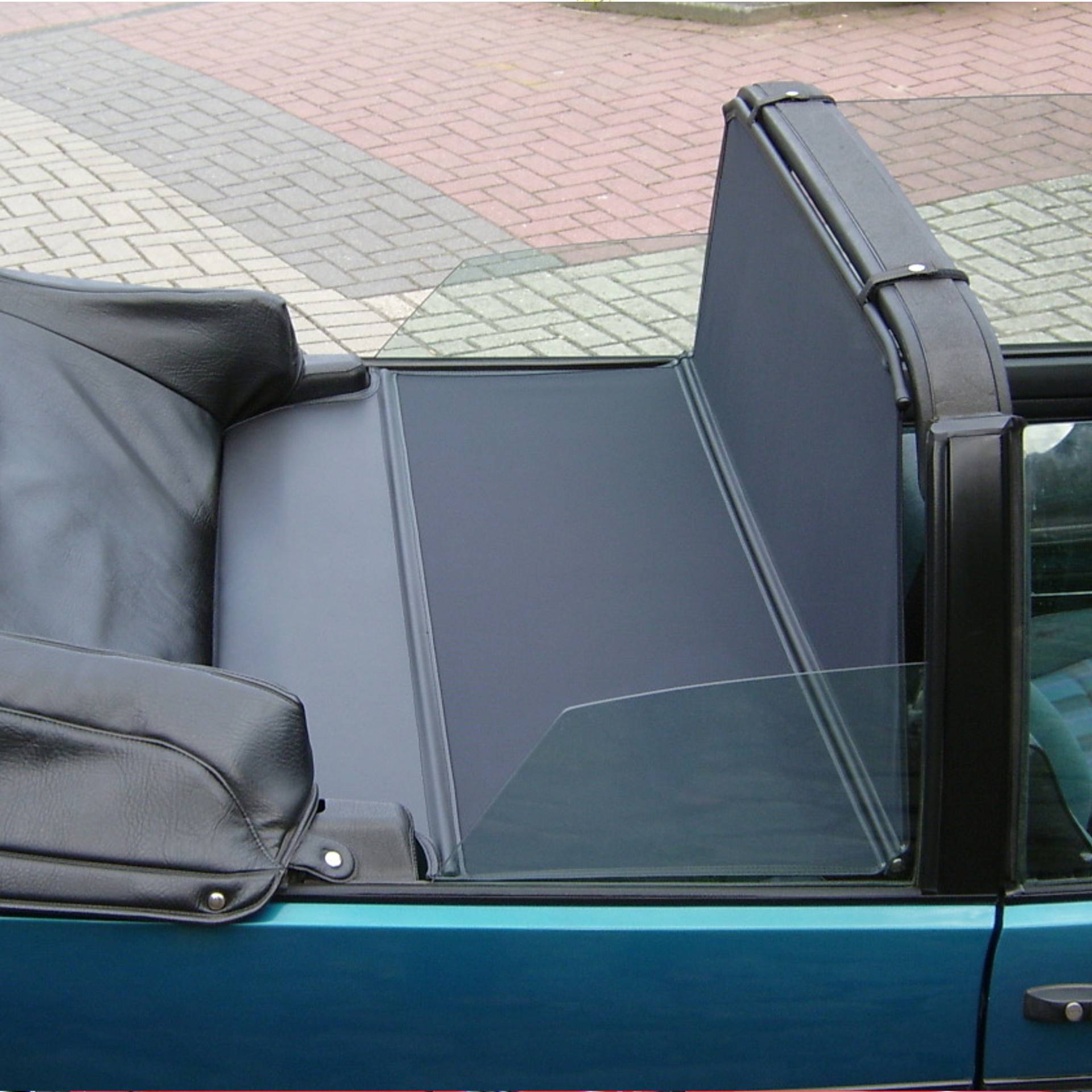 a green vw golf 1 convertible with a xl bodi wind deflector